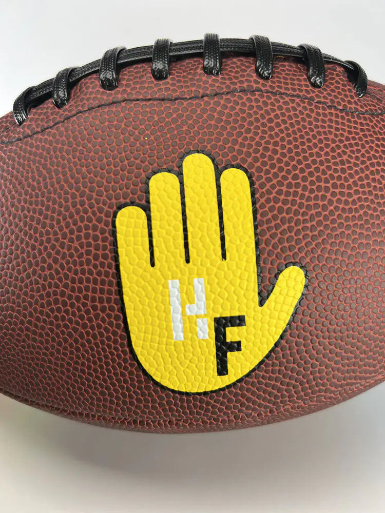 Football featuring yellow hand target graphic for improved catching technique training.