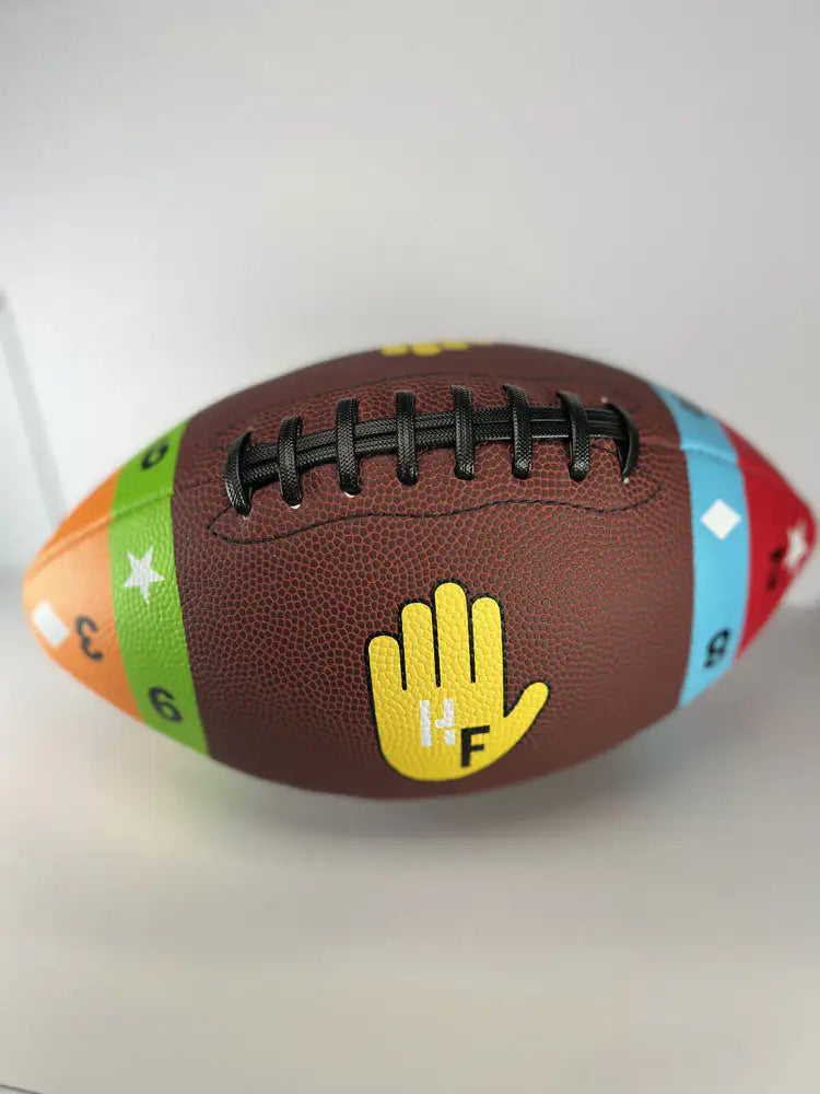 Training football with colorful numbered panels and hand target for skill development.